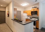 Thumbnail 3 of 31 - a kitchen with white appliances and wood cabinets and a counter top at Parc 1346, Chattanooga, TN, 37421