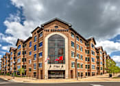 Thumbnail 1 of 15 - The Residence hotel with a flag on the building.