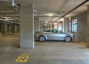 Thumbnail 15 of 15 - A silver car is parked in a parking garage.