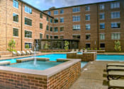 Thumbnail 13 of 15 - A pool with a fountain in the middle of it.