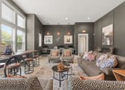 Thumbnail 23 of 31 - a living room with couches and chairs and a dining room table at The Ridge at Chenal Valley, Little Rock
