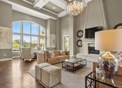 Thumbnail 29 of 31 - the living room has a fireplace and a large window at The Ridge at Chenal Valley, Little Rock, 72223