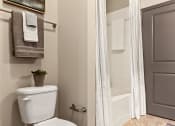 Thumbnail 11 of 31 - a bathroom with a toilet and a shower and a towel rack at The Ridge at Chenal Valley, Arkansas