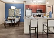 Thumbnail 1 of 31 - a kitchen with a bar and a dining room table at The Ridge at Chenal Valley, Little Rock, 72223