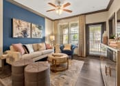 Thumbnail 3 of 31 - a living room with blue and white walls and a balcony at The Ridge at Chenal Valley, Little Rock