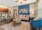 Thumbnail 5 of 31 - a living room with blue chairs and a geometric wallpaper at The Ridge at Chenal Valley, Arkansas