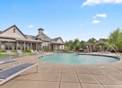 Thumbnail 14 of 31 - a resort style pool with lounge chairs and a building in the background at The Ridge at Chenal Valley, Little Rock, Arkansas