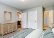 Thumbnail 3 of 13 - a bedroom with a bed and a dresser and a bathroom  at Serene at Creekstone, Athens, GA