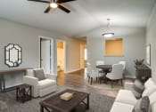 Thumbnail 2 of 13 - an open living room and dining room with a table and chairs  at Serene at Creekstone, Athens