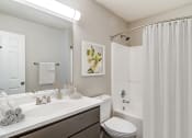 Thumbnail 4 of 13 - a bathroom with a shower and a sink and a toilet  at Serene at Creekstone, Georgia