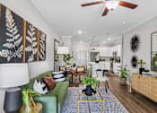 Thumbnail 5 of 43 - A living room with a green couch and a fan on the ceiling.