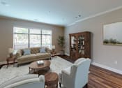 Thumbnail 4 of 15 - A living room with a couch, chair, and a cabinet.