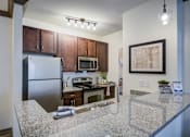 Thumbnail 2 of 38 - Kitchen with cabinets at The Ridge at Chenal Valley Apartments, Little Rock, Arkansas
