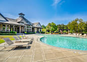 Thumbnail 16 of 38 - Sun loungers by the pool at The Ridge at Chenal Valley Apartments, Arkansas