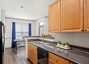 Thumbnail 15 of 38 - A kitchen with wooden cabinets at The Shallowford Apartments, Tennessee