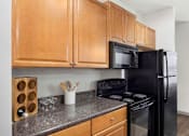 Thumbnail 13 of 38 - Kitchen With Black Appliances at The Shallowford Apartments, Chattanooga, TN
