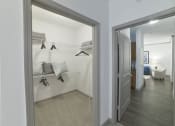 Thumbnail 9 of 27 - a bedroom with a closet and a mirror