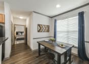Thumbnail 2 of 27 - a dining room with a large window and a table