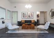 Thumbnail 19 of 29 - a living room with a black couch and two white chairs at The Summit Apartments, Memphis, 38128