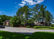 Thumbnail 17 of 29 - a view of a building with trees and a parking lot at The Summit Apartments, Memphis, TN, 38128