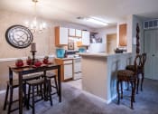 Thumbnail 1 of 29 - a kitchen and dining area with a large clock on the wall at The Summit Apartments, Memphis, Tennessee