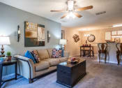 Thumbnail 3 of 29 - a living room with a couch and a ceiling fan at The Summit Apartments, Memphis
