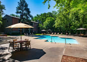 Thumbnail 9 of 29 - our apartments offer a swimming pool with tables and umbrellas at The Summit Apartments, Memphis, 38128