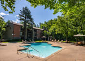 Thumbnail 10 of 29 - our apartments offer a swimming pool with chairs and trees at The Summit Apartments, Memphis, 38128