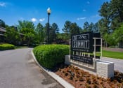 Thumbnail 27 of 29 - the summit apartments sign in front of a road with trees at The Summit Apartments, Memphis