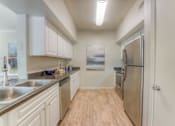 Thumbnail 8 of 30 - Kitchen with white cabinets at The Vineyards Apartments, Germantown, TN, 38138