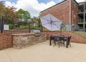 Thumbnail 14 of 14 - our patio has a grill and a table with chairs and an umbrella at The Waters at Chenal, Little Rock, Arkansas