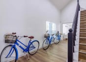 Thumbnail 10 of 14 - three bikes are lined up against a wall in a room with stairs at The Waters at Chenal, Arkansas, 72211