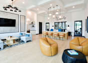 Thumbnail 25 of 29 - A modern lobby with a large TV and comfortable seating.