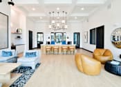 Thumbnail 26 of 29 - A spacious living lobby with a wooden floor and a variety of seating options.