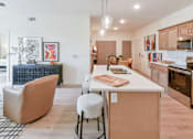Thumbnail 4 of 29 - A kitchen with a white counter top and wooden cabinets.