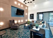 Thumbnail 20 of 29 - A TV mounted on a beautiful wood accent wall surrounded by modern furniture
