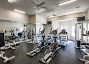 Thumbnail 16 of 28 - Trailside at Greenline spacious gym with a variety of equipment including treadmills, weights, and exercise machines.