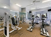 Thumbnail 17 of 33 - Gym with a variety of equipment including treadmills, stationary bikes, and weight machines at Trailside at Greenline, Cordova