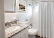 Thumbnail 8 of 19 - a bathroom with a sink and a toilet and a shower at Venue at Carrolton in Carrolton, GA 30117