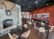 Thumbnail 19 of 22 - a dining room with tables and chairs and a fireplace at The Villa at River Pointe, Maumelle, AR 72213