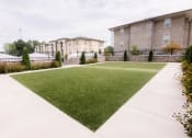 Thumbnail 15 of 22 - a green lawn in front of a building at The Villa at River Pointe, Arkansas, 72213