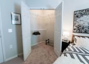 Thumbnail 6 of 22 - a bedroom with a bed and a bathroom with a shower