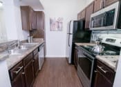 Thumbnail 4 of 22 - a kitchen with stainless steel appliances and marble counter tops at The Villa at River Pointe, Maumelle