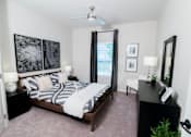 Thumbnail 5 of 22 - a bedroom with a bed and a ceiling fan