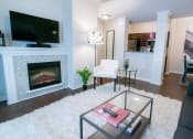 Thumbnail 2 of 22 - a living room with a fireplace and a television at The Villa at River Pointe, Arkansas, 72213