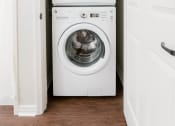 Thumbnail 9 of 22 - a white washer and dryer in a small laundry room at The Villa at River Pointe, Maumelle, 72213