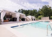 Thumbnail 12 of 22 - a swimming pool in front of a house with a pool at The Villa at River Pointe, Maumelle
