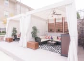 Thumbnail 14 of 22 - a patio with a white canopy and a living room with white curtains at The Villa at River Pointe, Arkansas, 72213