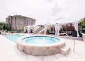 Thumbnail 10 of 22 - our apartments have a large pool and spa with umbrellas at The Villa at River Pointe, Maumelle, Arkansas
