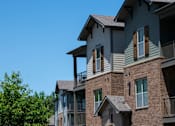 Thumbnail 25 of 26 - A row of houses with balconies and windows. at Hall Creek Apartment Homes, Arlington, Tennessee